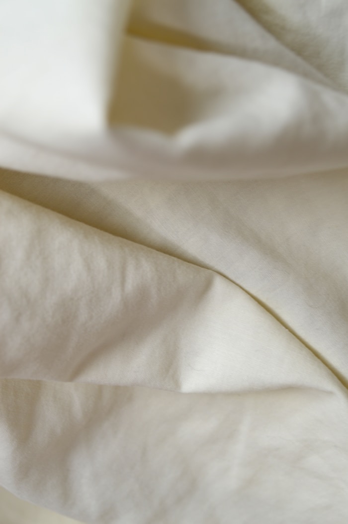 White textile on brown wooden table